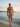 Bandera men's swim trunks walking out of the sea at dawn — House of Yas editorial