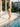 White Tiles swimsuit descending marble steps into a still pool at a Havana estate — House of Yas editorial