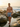 Blue Tiles men's swim trunks among coastal rocks and tide pools at golden hour — House of Yas editorial