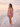 Pink Cuba string bikini on a quiet pastel beach at sunrise — House of Yas editorial